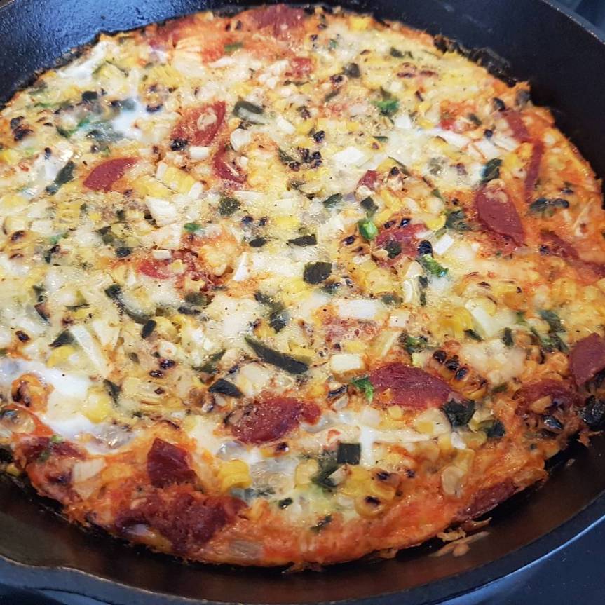 Mexican frittata with grilled corn and poblano, chorizo and asiago cheese.